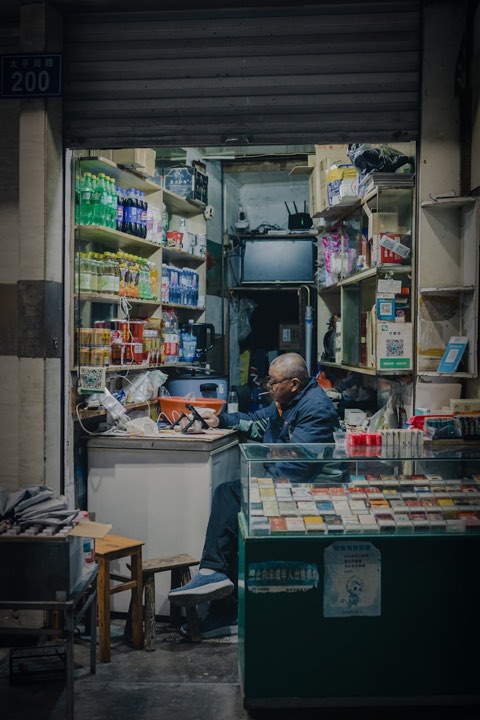 Owner behind the counter of a small shop