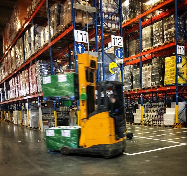 Forklift moving pallets through a warehouse